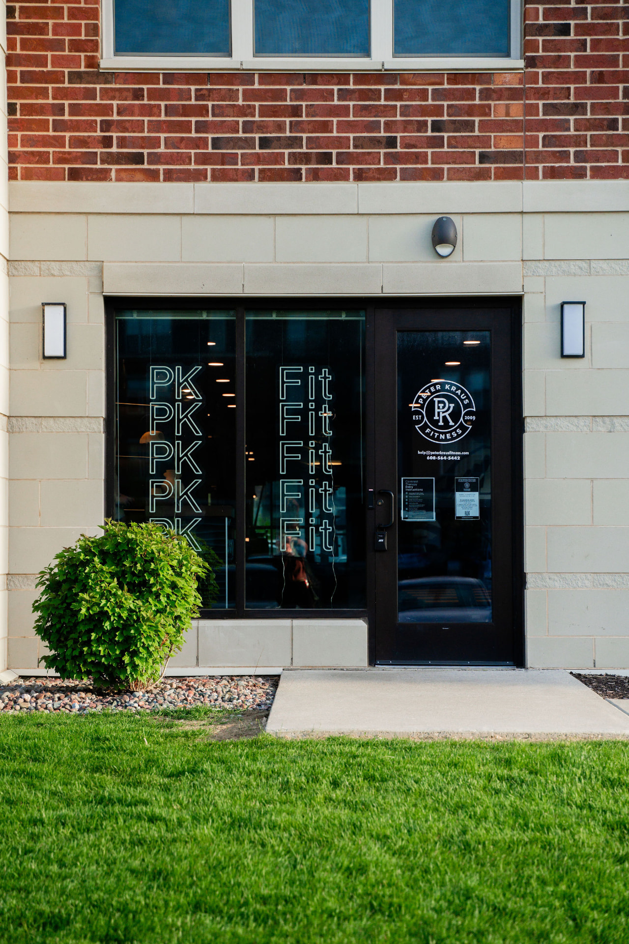 The PKFit storefront entrance with its glass doors and windows